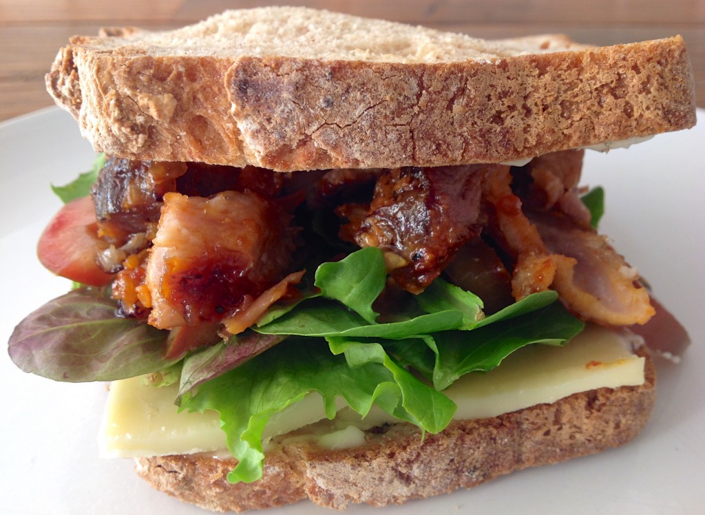 sandwich with ribs, greens and cheese